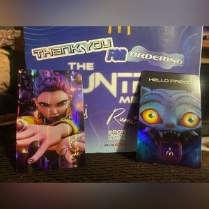 2 Kpop Huntrix holographic cards From McDonald’s 
Ruin and Derby !💜💙